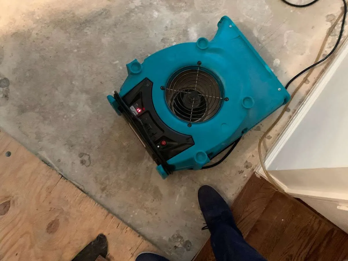 Air mover drying subfloor during Commercial Water Damage Restoration in Woodmoor